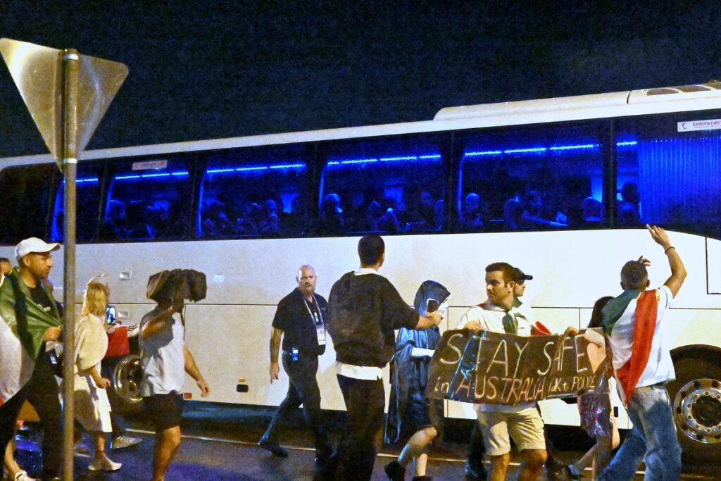 Supporters react towards a bus transporting Iranian woman players following their Women's Asian Cup soccer match against the Philippines on the Gold Coast, Australia, Sunday, March 8, 2026. (Dave Hunt/AAP Image via AP))