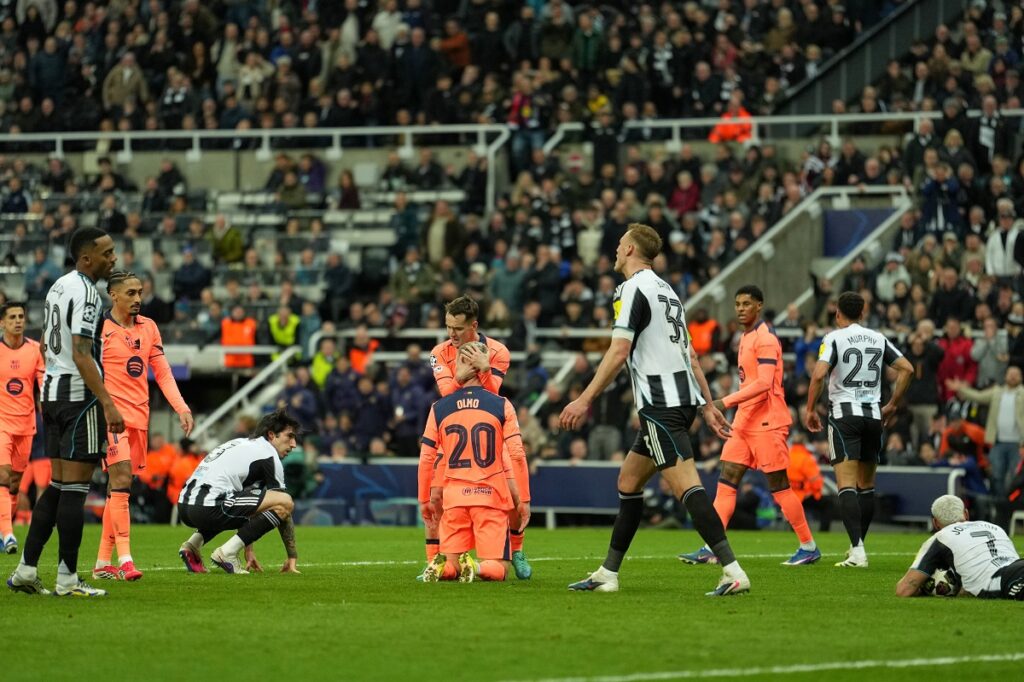 Barcelona's Dani Olmo is greeted by teammates after he was fouled and got a penalty during the Champions League round of 16 first leg soccer match between Newcastle United and Barcelona in Newcastle , England, Tuesday, March 10, 2026. (AP Photo/Jon Super)