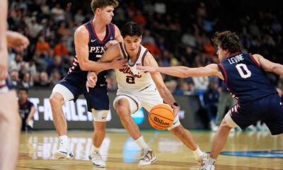 Illinois guard Andrej Stojakovic drives to the basket between Pennsylvania forward Michael Zanoni and guard AJ Levine during the second half in the first round of the NCAA college basketball tournament, Thursday, March 19, 2026, in Greenville, S.C. (AP Photo/Chris Carlson)