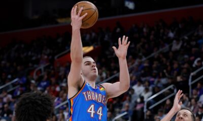 Oklahoma City Thunder guard Nikola Topic (44) goes to the basket between Detroit Pistons guard Cade Cunningham (2) and forward Duncan Robinson (55) during the second half of an NBA basketball game, Wednesday, Feb. 25, 2026, in Detroit. (AP Photo/Duane Burleson)