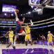 Washington Wizards forward Tristan Vukcevic, second from left, dunks against Los Angeles Lakers center Deandre Ayton, left, and Los Angeles Lakers forward Rui Hachimura, center, during the first half of an NBA basketball game Monday, March 30, 2026, in Los Angeles. (AP Photo/Ryan Sun)