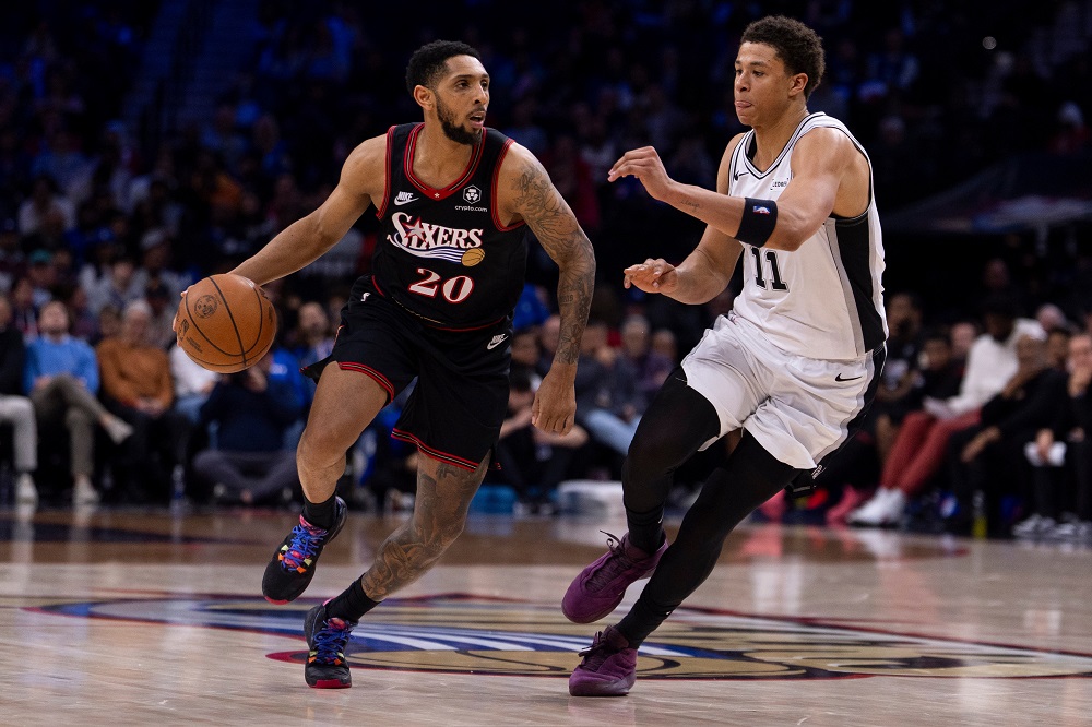 Philadelphia 76ers' Cameron Payne, left, drives to the basket against San Antonio Spurs' Carter Bryant, right, during the second half of an NBA basketball game, Tuesday, March 3, 2026, in Philadelphia. (AP Photo/Chris Szagola)