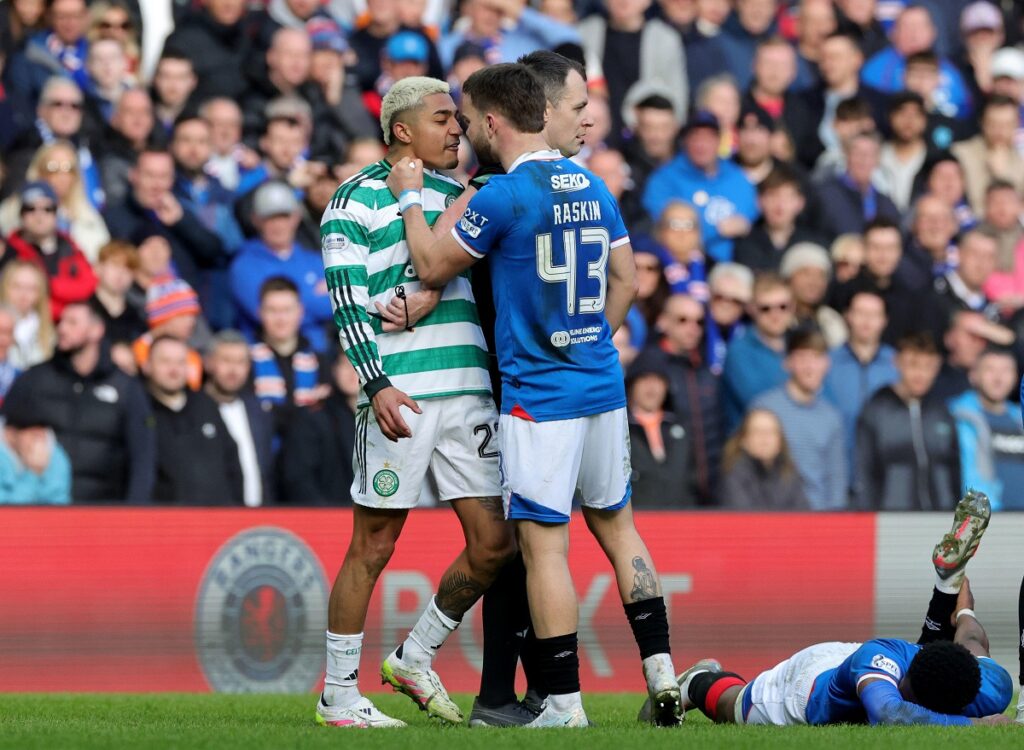 Celtic's Julian Araujo, center left and Rangers' Nicolas Raskin clash, during the Scottish Cup quarterfinal soccer match between Rangers and Celtic, in Glasgow, Scotland, Sunday March 8, 2026. (Steve Welsh/PA via AP)
