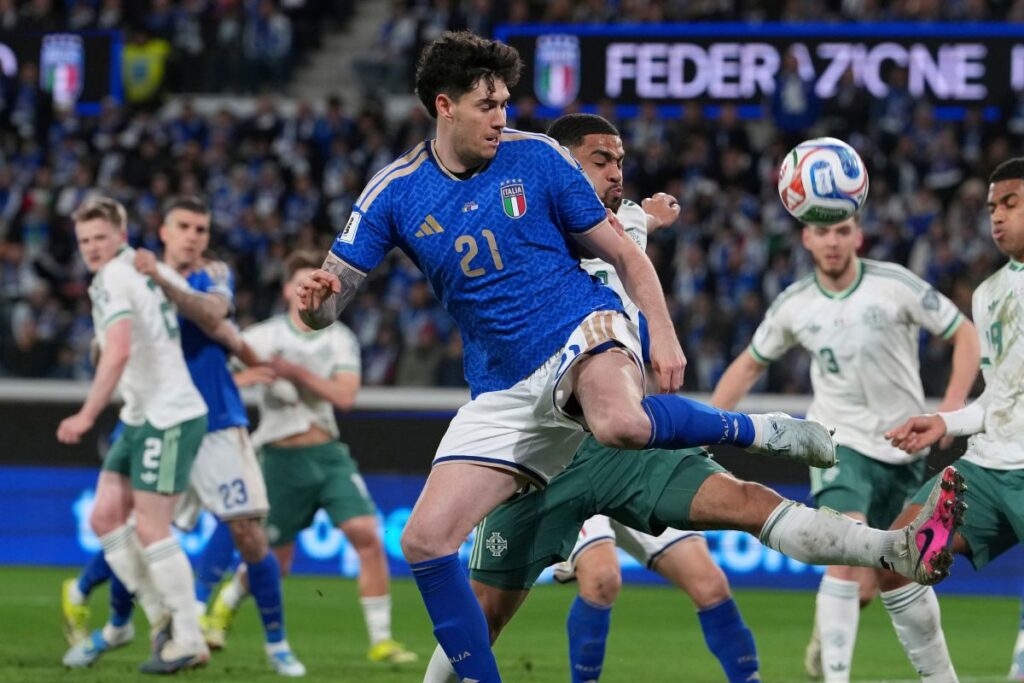 Italy's Alessandro Bastoni, front, and Northern Ireland's Shea Charles vie for the ball during the World Cup qualifying play-off soccer match between Italy and Northern Ireland, in Bergamo, Italy, Thursday, March 26, 2026. (AP Photo/Antonio Calanni)