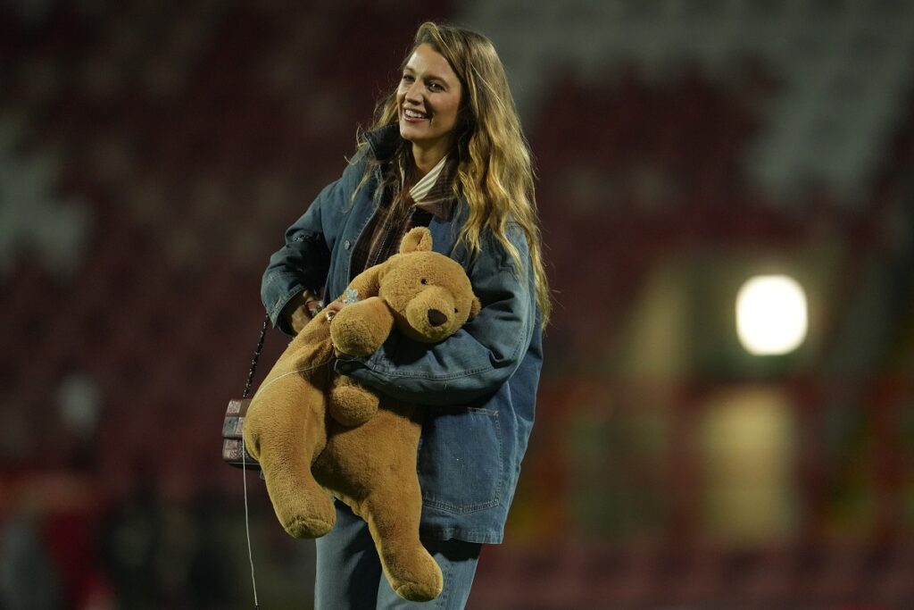 American actress Blake Lively walks on the pitch after the fifth round FA Cup soccer match between Wrexham and Chelsea in Wrexham, Wales, Saturday, March 7, 2026. (AP Photo/Jon Super)