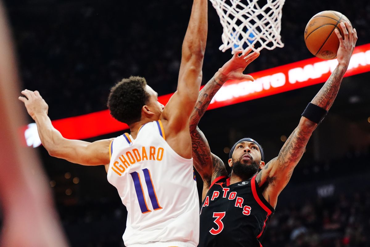 Toronto Raptors' Brandon Ingram (3) shoots past Phoenix Suns' Oso Ighodaro (11) during the first half of an NBA basketball game in Toronto, Friday, March 13, 2026. (Frank Gunn/The Canadian Press via AP)