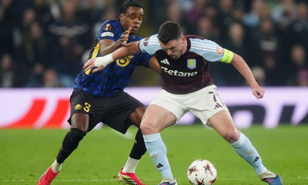 Lille's Nathan Ngoy, left, and Aston Villa's John McGinn, right, challenge for the ball during the Europa League round of sixteen second leg soccer match between Aston Villa and LOSC Lille in Birmingham, England, Thursday, March 19, 2026. (David Davies/PA via AP)