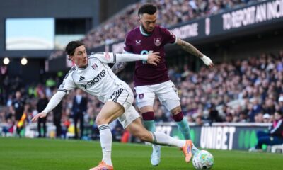 Fulham's Harry Wilson and Burnley's Quilindschy Hartman, right, battle for the ball during the Premier League match between Fulham and Burnley, in London, Saturday March 21, 2026. (John Walton/PA via AP)