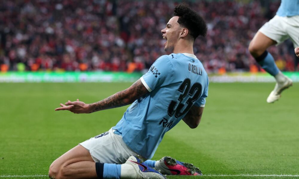 Manchester City's Nico O'Reilly celebrates after scoring the opening goal during the English League Cup final soccer match between Arsenal and Manchester City in London, Sunday, March 22, 2026. (AP Photo/Richard Pelham)