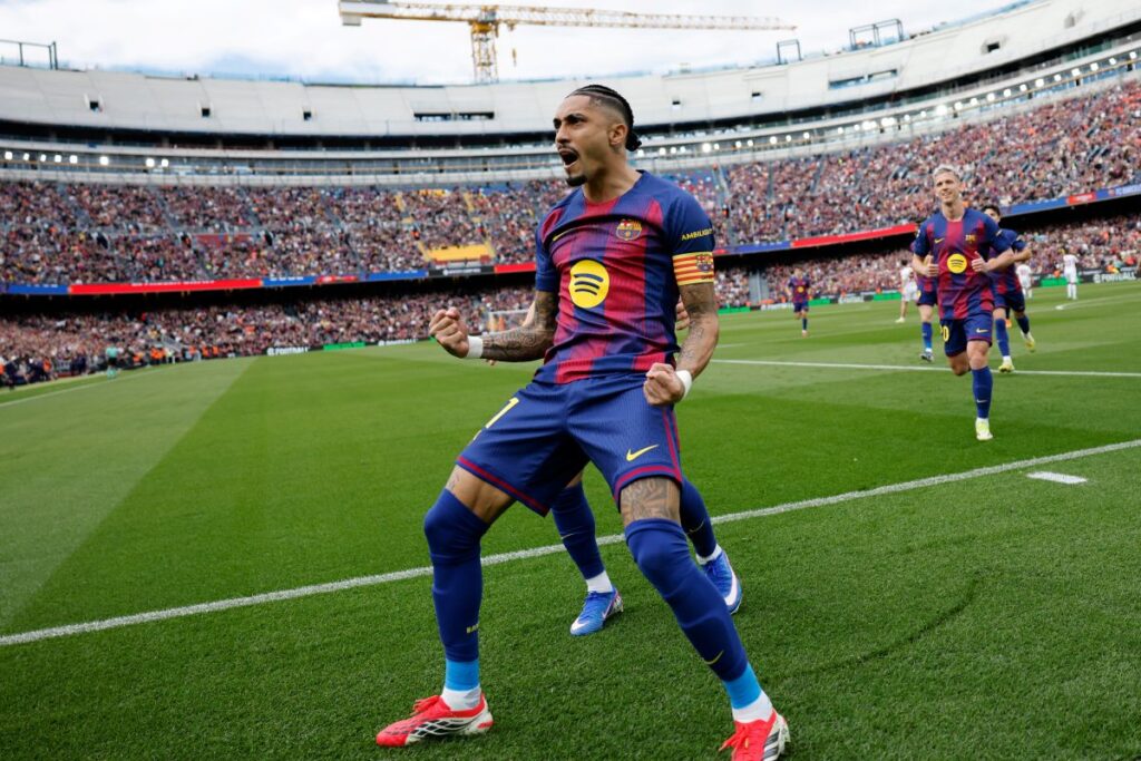 Barcelona's Raphinha celebrates after scoring his side's opening goal during the Spanish La Liga soccer match between Barcelona and Sevilla in Barcelona, Spain, Sunday, March 15, 2026. (AP Photo/Joan Monfort)