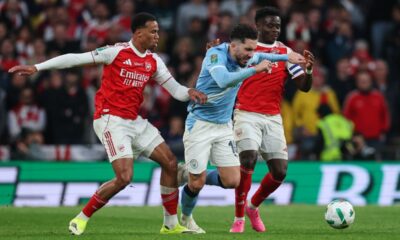 Arsenal's Gabriel, left, and Bukayo Saka, challenge Manchester City's Rayan Cherki during the English League Cup final soccer match between Arsenal and Manchester City in London, Sunday, March 22, 2026. (AP Photo/Richard Pelham)