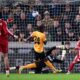 Liverpool's Mohamed Salah, right, scores their second goal of the game during an English FA Cup fifth round match against Wolverhampton Wanderers, Friday, March 6, 2026, in Wolverhampton, England. (Peter Byrne/PA via AP)