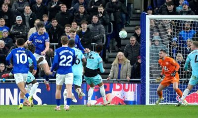 Everton's James Tarkowski, top left, scores their side's first goal of the game during their English Premier League soccer match against Burnley in Liverpool, England, Tuesday, March 3, 2026. (Peter Byrne/PA via AP)