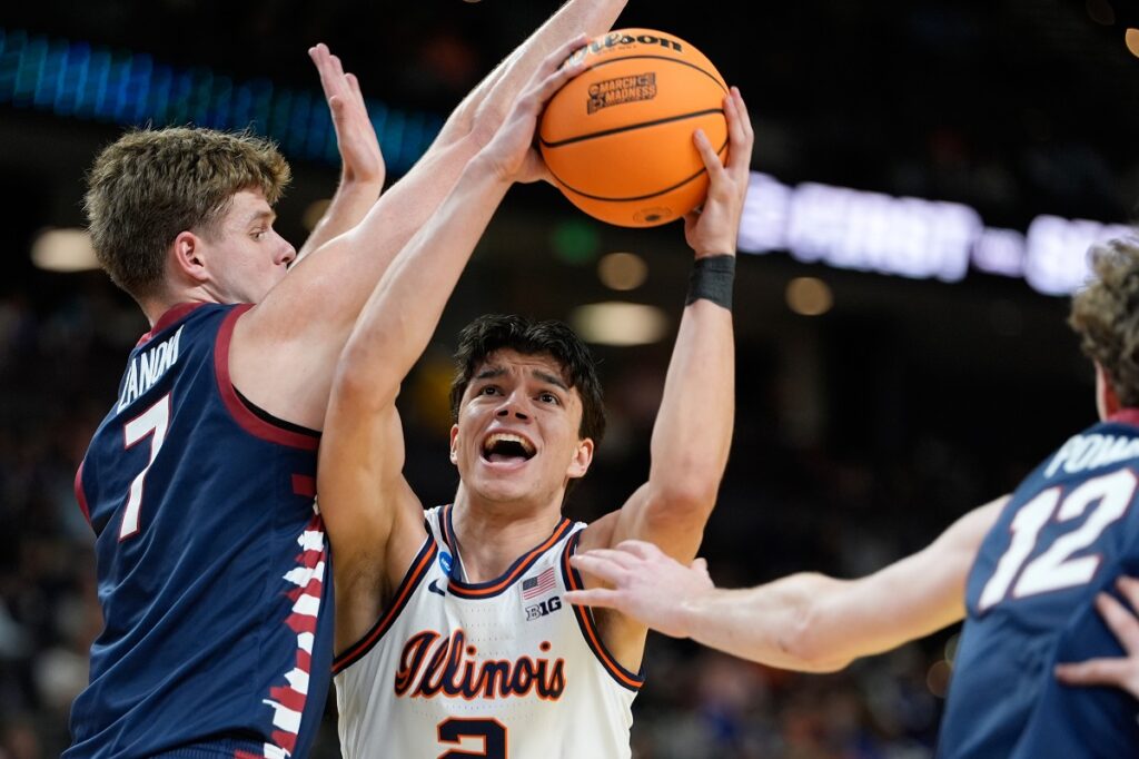 Illinois guard Andrej Stojakovic (2) shoots against Pennsylvania guard Michael Zanoni (7) during the first half in the first round of the NCAA college basketball tournament, Thursday, March 19, 2026, in Greenville, S.C. (AP Photo/Brynn Anderson)