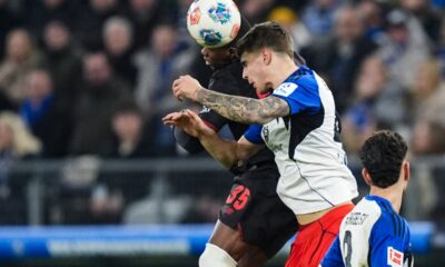 Leverkusen's Christian Kofane, left, fights for the ball with Hamburger's Luka Vuskovic during the Bundesliga soccer match between Hamburger SV and Bayer Leverkusen, in Hamburg, Germany, Wednesday March 4, 2026. (Marcus Brandt/dpa via AP)