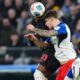 Leverkusen's Christian Kofane, left, fights for the ball with Hamburger's Luka Vuskovic during the Bundesliga soccer match between Hamburger SV and Bayer Leverkusen, in Hamburg, Germany, Wednesday March 4, 2026. (Marcus Brandt/dpa via AP)