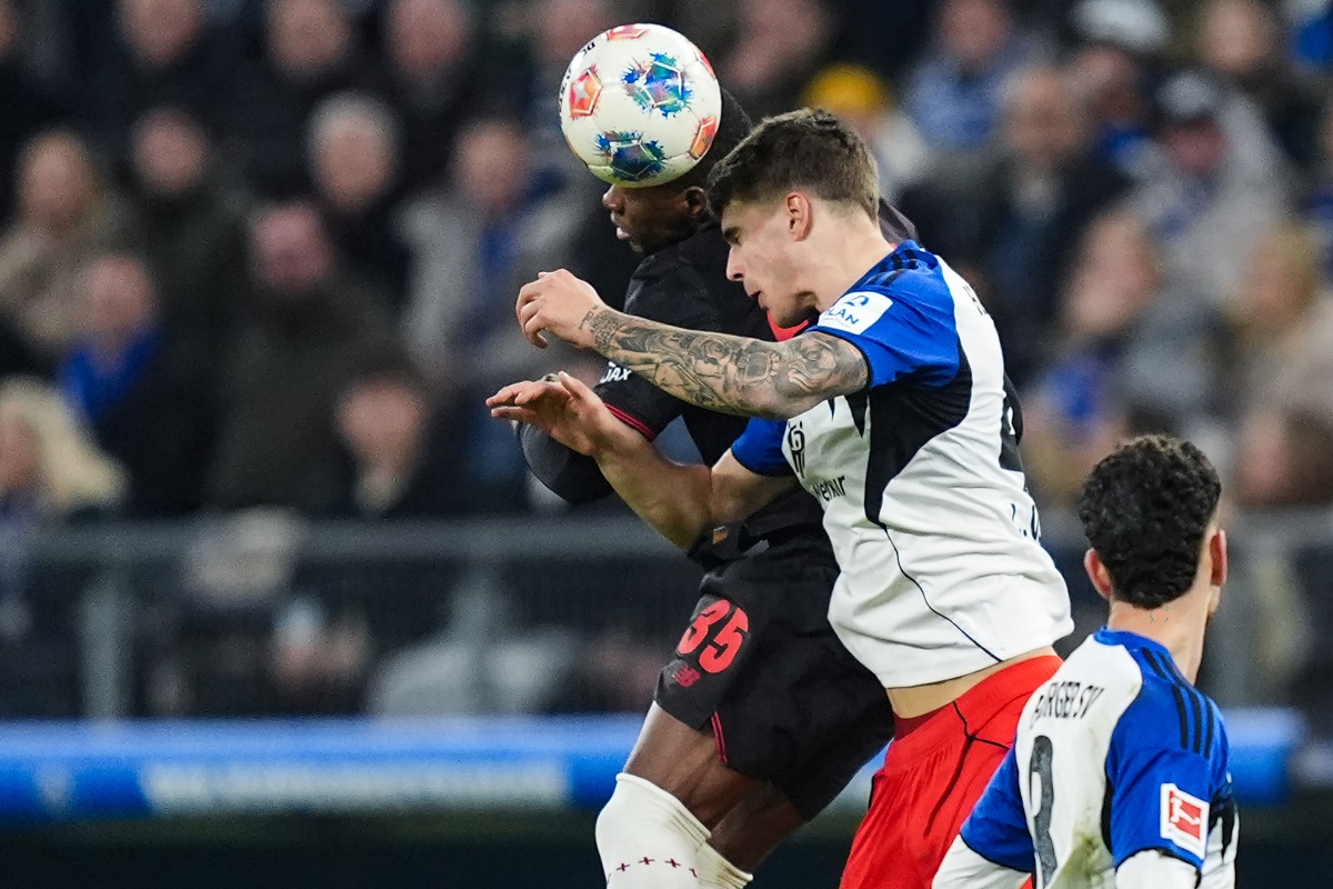 Leverkusen's Christian Kofane, left, fights for the ball with Hamburger's Luka Vuskovic during the Bundesliga soccer match between Hamburger SV and Bayer Leverkusen, in Hamburg, Germany, Wednesday March 4, 2026. (Marcus Brandt/dpa via AP)