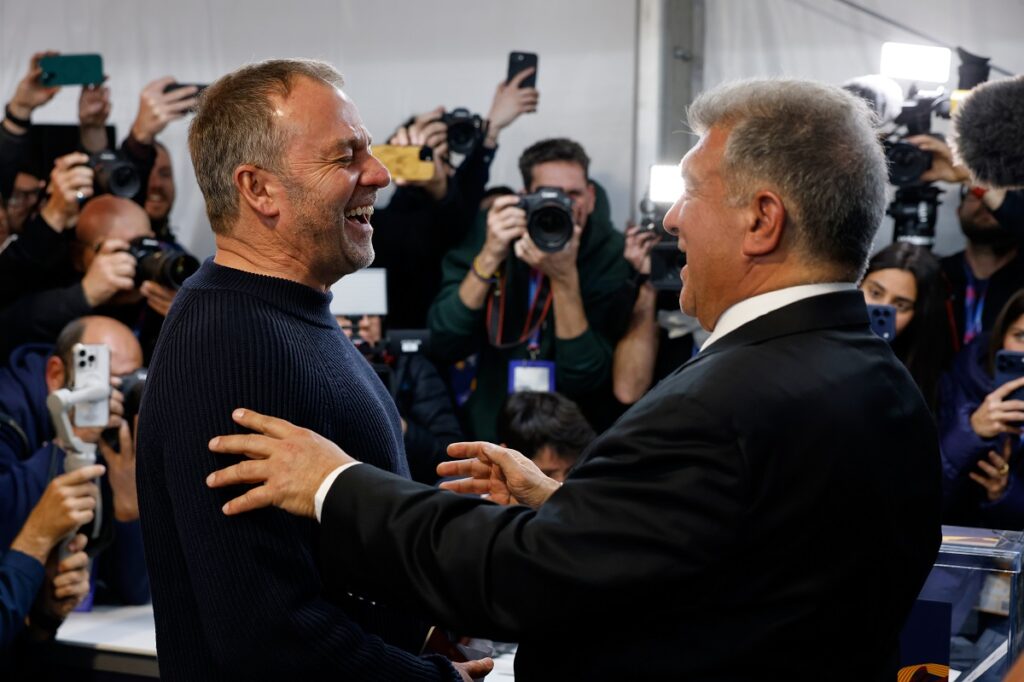 Joan Laporta reacts as he greets Barcelona's head coach Hansi Flick, left, after the voting for the election to be president of FC Barcelona in Barcelona, Spain, Sunday, March 15, 2026. (AP Photo/Joan Monfort)
