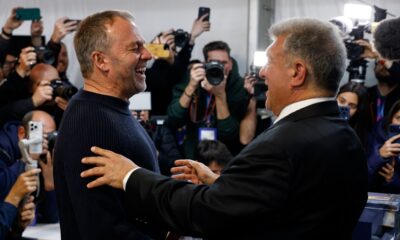 Joan Laporta reacts as he greets Barcelona's head coach Hansi Flick, left, after the voting for the election to be president of FC Barcelona in Barcelona, Spain, Sunday, March 15, 2026. (AP Photo/Joan Monfort)