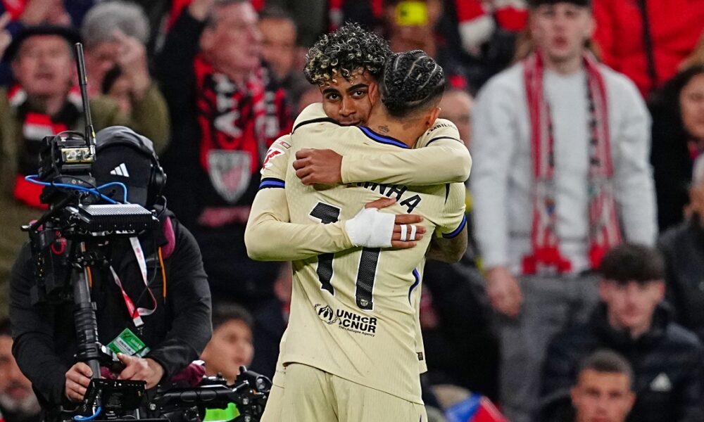 Barcelona's Lamine Yamal, back, is congratulated after scoring his side's opening goal during the Spanish La Liga soccer match between Athletic Bilbao and Barcelona in Bilbao, Spain, Saturday, March 7, 2026. (AP Photo/Miguel Oses)