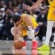 Los Angeles Lakers guard Luka Dončić reacts after getting hit in the face by the ball in the first half of an NBA basketball game against the Denver Nuggets Thursday, March 5, 2026, in Denver. (AP Photo/David Zalubowski)