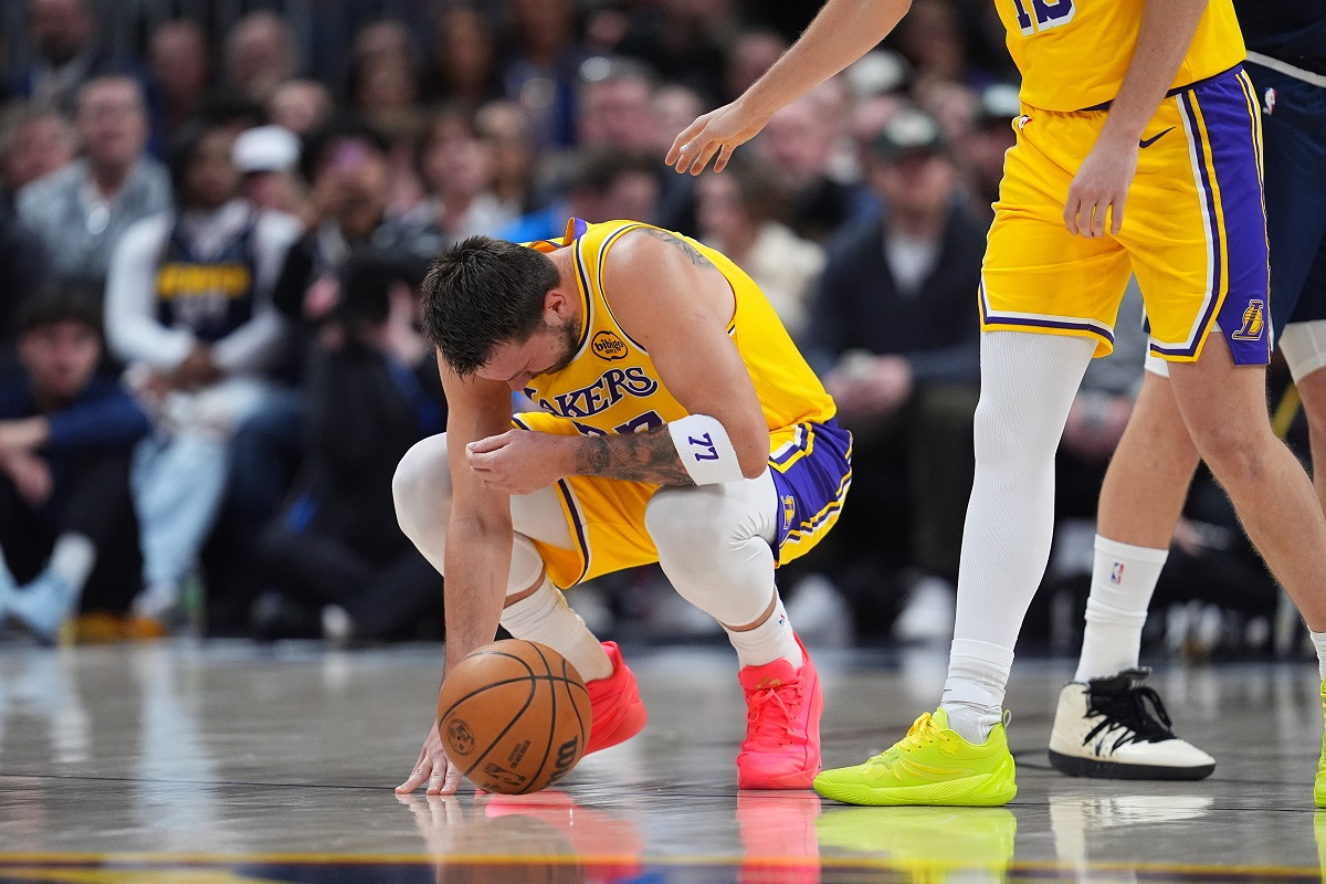 Los Angeles Lakers guard Luka Dončić reacts after getting hit in the face by the ball in the first half of an NBA basketball game against the Denver Nuggets Thursday, March 5, 2026, in Denver. (AP Photo/David Zalubowski)