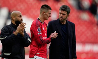 Manchester United's Benjamin Sesko shakes hands with coach Michael Carrick after the Premiier League soccer match between Manchester United and Crystal Palace in Manchester, England, Sunday, March 1, 2026. (AP Photo/Dave Thompson)