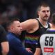 Denver Nuggets center Nikola Jokić, back right, argues for a call after being hit in the nose as assistant coach J.J. Barea, back left, intercedes with referees Ray Acosta, front left, and Josh Tiven in the first half of an NBA basketball game against the San Antonio Spurs, Saturday, April 4, 2026, in Denver. (AP Photo/David Zalubowski)