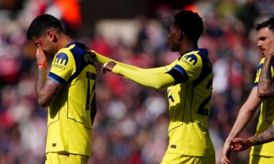 Tottenham Hotspur's Cristian Romero, left, leaves the field after colliding with his team mate Tottenham Hotspur goalkeeper Antonin Kinsky during the Premier League soccer match between Sunderland and Tottenham Hotspur, in Sunderland, England, Sunday April 12, 2026. (Owen Humphreys/PA via AP)