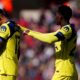 Tottenham Hotspur's Cristian Romero, left, leaves the field after colliding with his team mate Tottenham Hotspur goalkeeper Antonin Kinsky during the Premier League soccer match between Sunderland and Tottenham Hotspur, in Sunderland, England, Sunday April 12, 2026. (Owen Humphreys/PA via AP)