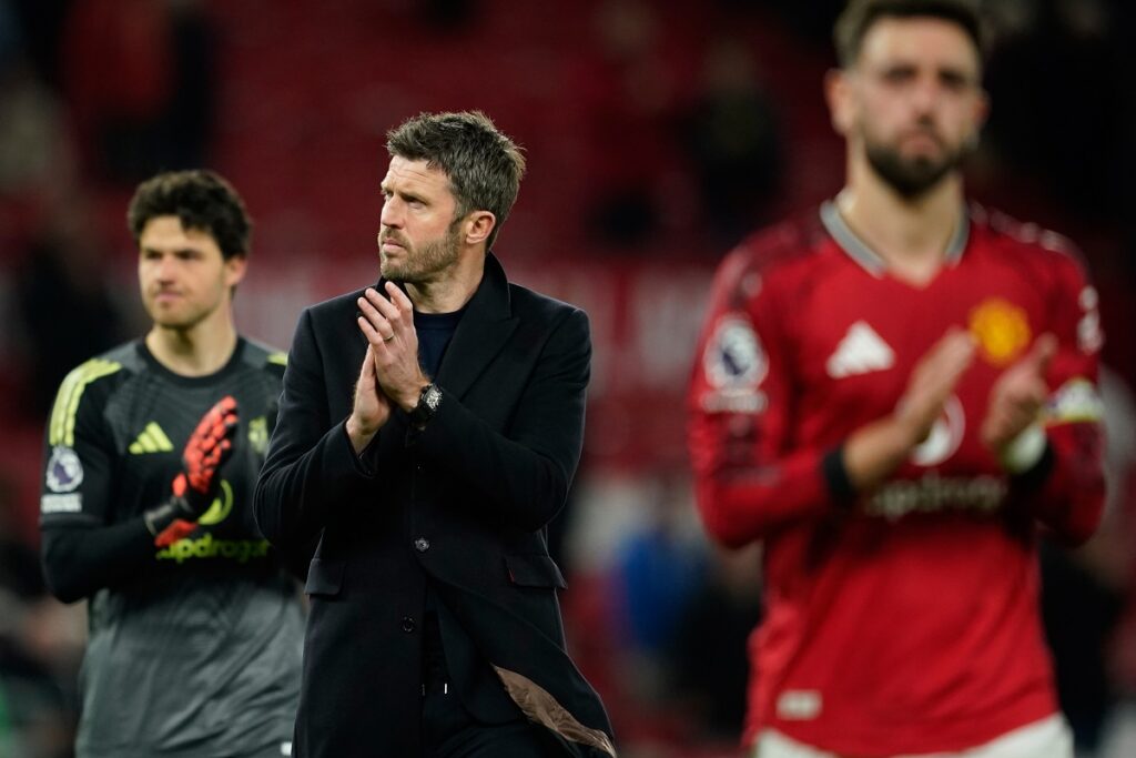 Manchester United's coach Michael Carrick walks off the pitch after the Premiier League soccer match between Manchester United and Leeds in Manchester, England, Monday, April 13, 2026. (AP Photo/Dave Thompson)