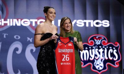 UCLA Angela Dugalic poses with WNBA commissioner Cathy Engelbert after being selected ninth overall by the Washington Mystics in the first round of the WNBA basketball draft Monday, April 13, 2026, in New York. (AP Photo/Pamela Smith)