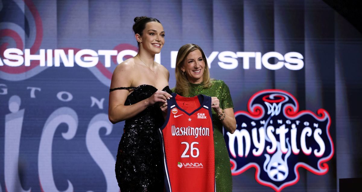 UCLA Angela Dugalic poses with WNBA commissioner Cathy Engelbert after being selected ninth overall by the Washington Mystics in the first round of the WNBA basketball draft Monday, April 13, 2026, in New York. (AP Photo/Pamela Smith)