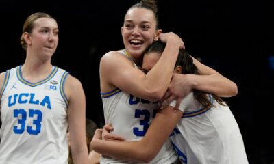 UCLA forward Angela Dugalic, second from left, embraces UCLA guard Lena Bilic (9) after defeating Texas in a women's NCAA college basketball tournament semifinal game at the Final Four, Friday, April 3, 2026, in Phoenix. (AP Photo/Ross D. Franklin)