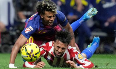 Barcelona's Lamine Yamal, top, is tackled and fouled by Atletico Madrid's Nico Gonzalez, who receives a second yellow card and is then sent off during a La Liga soccer match between Atletico Madrid and Barcelona in Madrid, Spain, Saturday, April 4, 2026. (AP Photo/Bernat Armangue)
