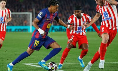 Barcelona's Lamine Yamal in action against Atletico Madrid's Matteo Ruggeri, left, and Atletico Madrid's Ademola Lookman during the Champions League quarterfinal first leg soccer match between Barcelona and Atletico Madrid in Barcelona, Spain, Wednesday, April 8, 2026. (AP Photo/Joan Monfort)
