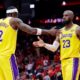 Los Angeles Lakers forwards Jarred Vanderbilt (2) and LeBron James (23) celebrate after their overtime win against the Houston Rockets in Game 3 of a first-round NBA playoffs basketball series Friday April 24, 2026, in Houston. (AP Photo/Michael Wyke)