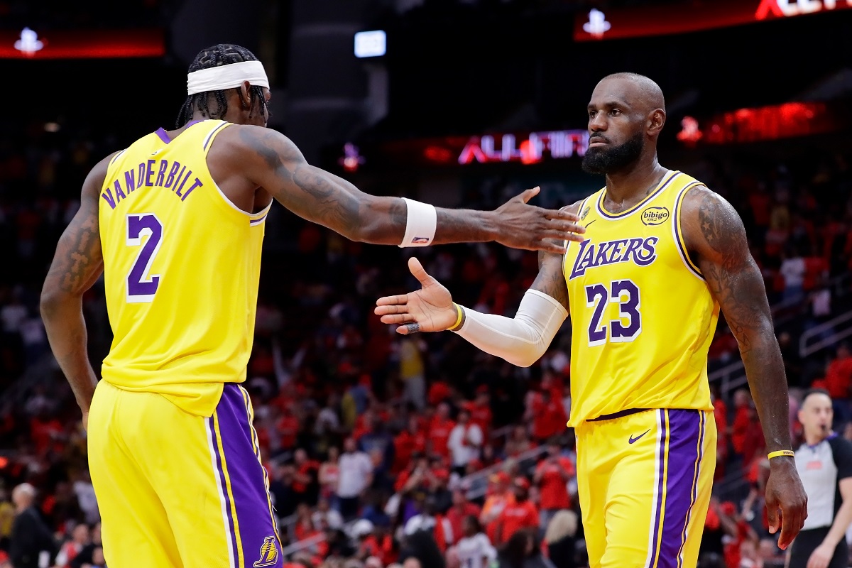 Los Angeles Lakers forwards Jarred Vanderbilt (2) and LeBron James (23) celebrate after their overtime win against the Houston Rockets in Game 3 of a first-round NBA playoffs basketball series Friday April 24, 2026, in Houston. (AP Photo/Michael Wyke)