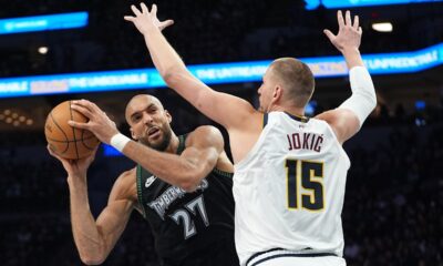 Minnesota Timberwolves center Rudy Gobert (27) handles the ball as Denver Nuggets center Nikola Jokic (15) defends during the second half in Game 3 of a first-round NBA basketball playoff series, Thursday, April 23, 2026, in Minneapolis. (AP Photo/Abbie Parr)