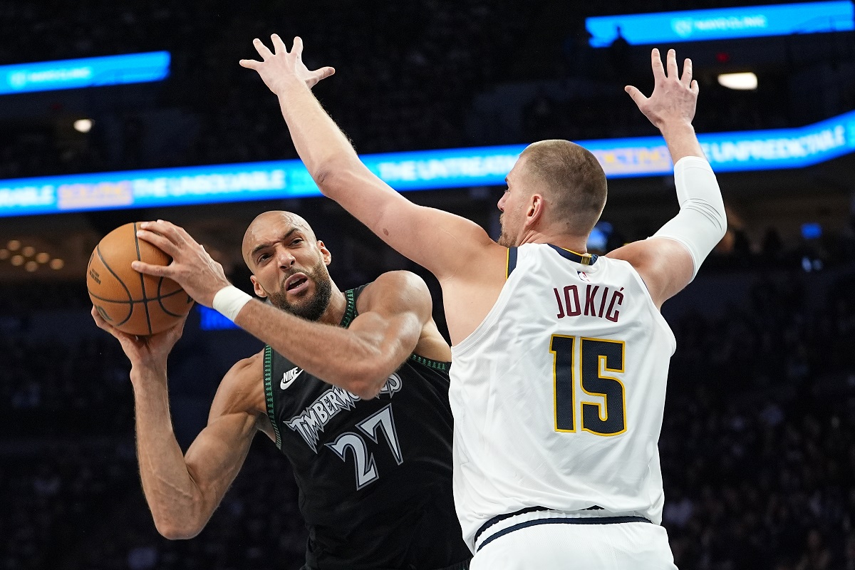 Minnesota Timberwolves center Rudy Gobert (27) handles the ball as Denver Nuggets center Nikola Jokic (15) defends during the second half in Game 3 of a first-round NBA basketball playoff series, Thursday, April 23, 2026, in Minneapolis. (AP Photo/Abbie Parr)
