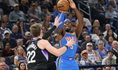 Oklahoma City Thunder guard Luguentz Dort (5) looks to shoot over Utah Jazz forward Kyle Filipowski (22) during the first half of an NBA basketball game Sunday, April 5, 2026, in Oklahoma City. (AP Photo/Nate Billings)