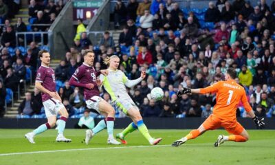 Manchester City's Erling Haaland, second right, scores his side's opening goal during the Premier League soccer match between Burnley and Manchester City in Burnley, England, Wednesday, April 22, 2026. (Nick Potts/PA via AP)