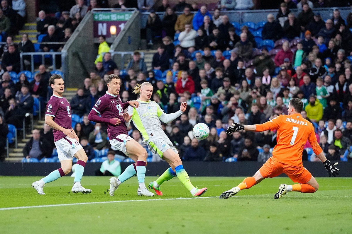 Manchester City's Erling Haaland, second right, scores his side's opening goal during the Premier League soccer match between Burnley and Manchester City in Burnley, England, Wednesday, April 22, 2026. (Nick Potts/PA via AP)