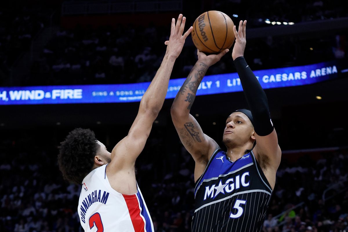 Orlando Magic forward Paolo Banchero (5) looks to shoot against Detroit Pistons guard Cade Cunningham, left, during the second half in Game 1 of a first-round NBA basketball playoffs series Sunday, April 19, 2026, in Detroit. (AP Photo/Duane Burleson)