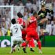Bayern's goalkeeper Manuel Neuer heads the ball to save before Real Madrid's Vinicius Junior, left, can score during the Champions League quarterfinal first leg soccer match between Real Madrid and Bayern Munich in Madrid, Spain, Tuesday, April 7, 2026. (AP Photo/Jose Breton)