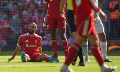 Liverpool's Mohamed Salah smiles as he sits on the pitch after getting injured during the English Premier League soccer match between Liverpool and Crystal Palace in Liverpool, England, Saturday, April 25, 2026. (AP Photo/Ian Hodgson)