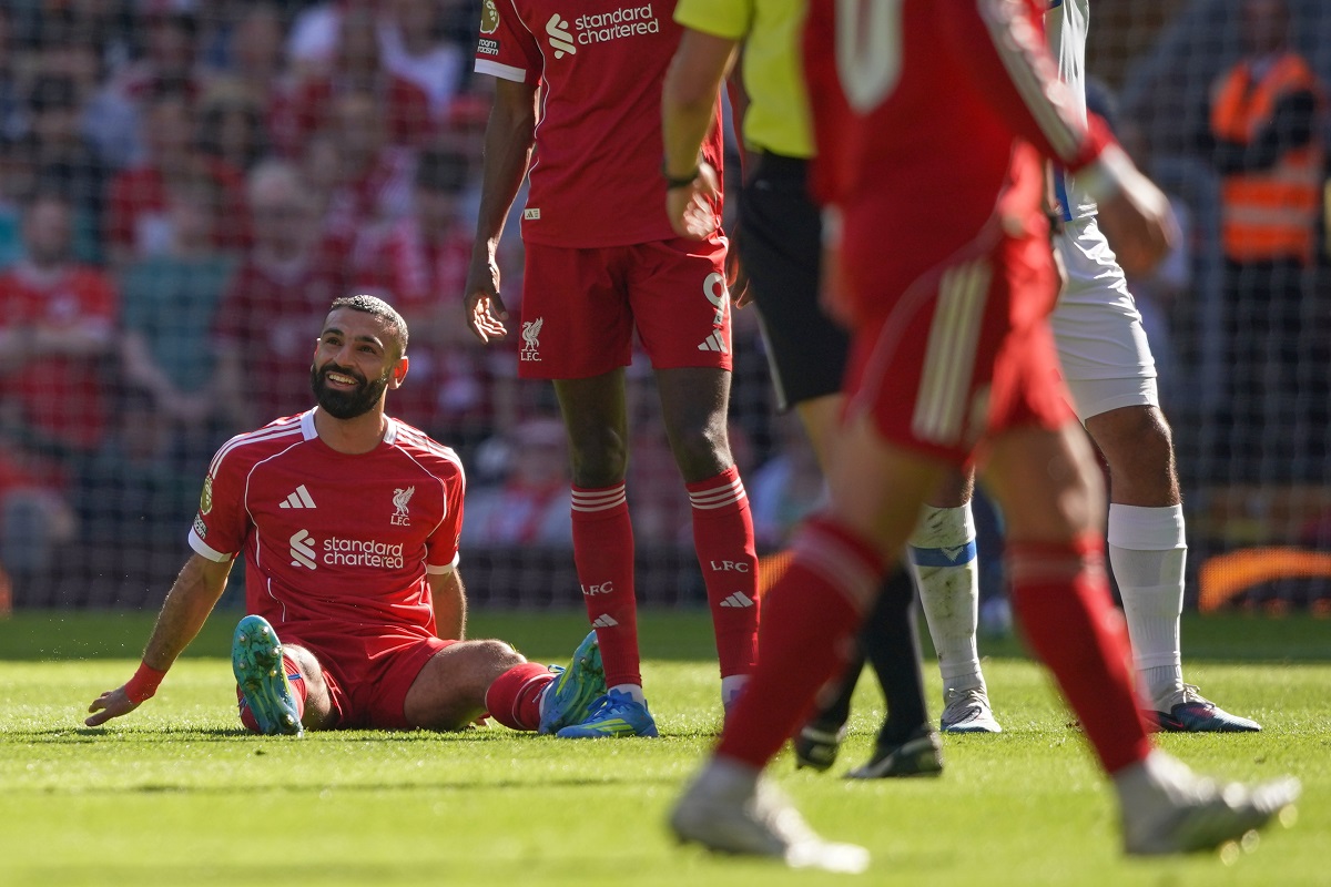 Liverpool's Mohamed Salah smiles as he sits on the pitch after getting injured during the English Premier League soccer match between Liverpool and Crystal Palace in Liverpool, England, Saturday, April 25, 2026. (AP Photo/Ian Hodgson)