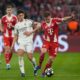 Real Madrid's Arda Guler, left, challenges for the ball with Bayern's Joshua Kimmich during the Champions League quarterfinal second leg soccer match between Bayern Munich and Real Madrid in Munich, Germany, Wednesday, April 15, 2026. (AP Photo/Matthias Schrader)
