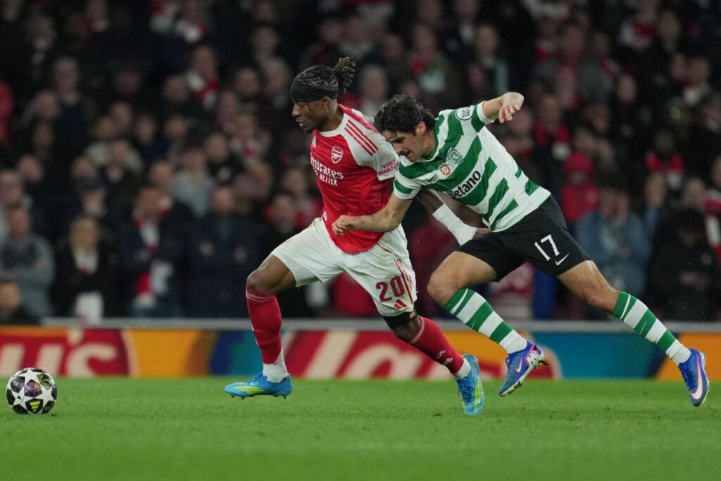Arsenal's Noni Madueke, left, and Sporting's Francisco Trincao fight for the ball during the UEFA Champions League second leg quarterfinal soccer match between Arsenal and Sporting in London, England, Wednesday, April 15, 2026. (AP Photo/Kin Cheung)
