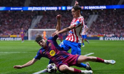 Barcelona's Fermin Lopez, front, and Atletico Madrid's Nahuel Molina challenge for the ball during the Champions League quarterfinal second leg soccer match between Atletico Madrid and Barcelona in Madrid, Spain, Tuesday, April 14, 2026. (AP Photo/Manu Fernandez)